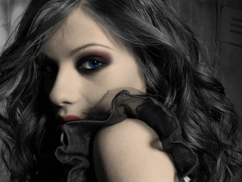 woman with blue eyes and dark makeup