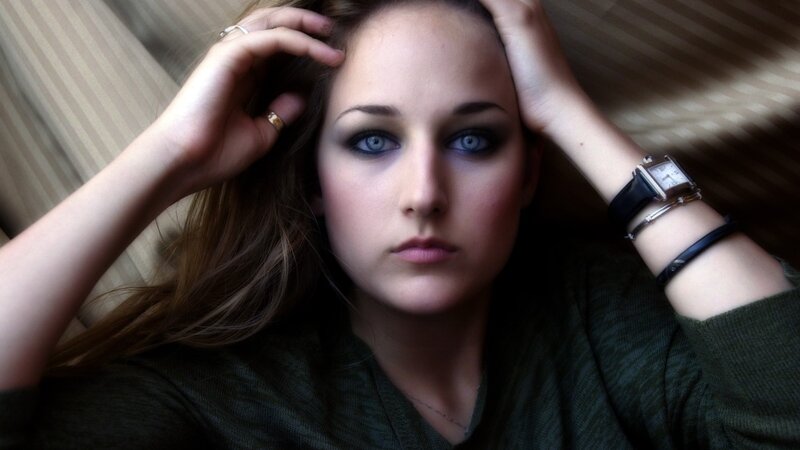 woman with blue eyes and dark makeup