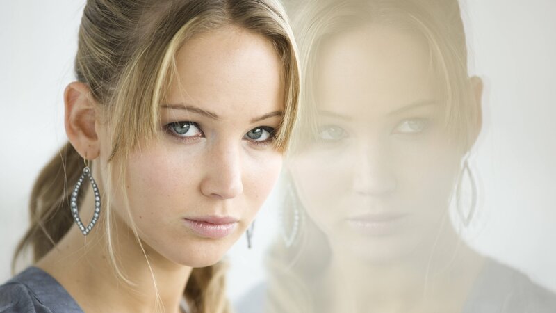 woman with blue eyes and earrings