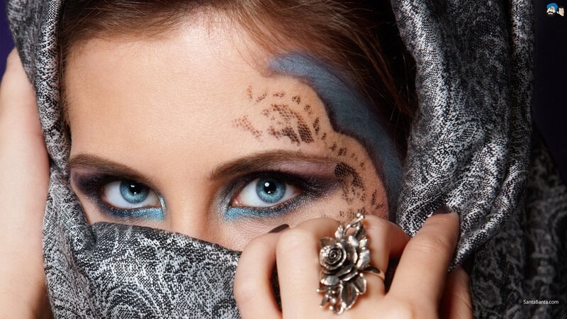 woman with blue eyes and face paint