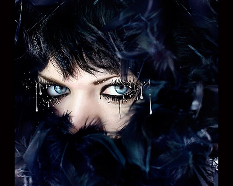 woman with blue eyes and feathers
