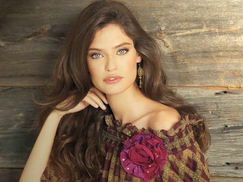woman with blue eyes and floral dress