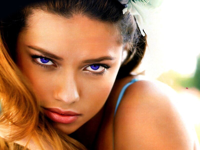 woman with blue eyes and flower