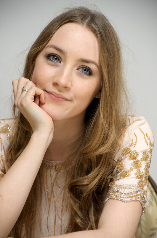 woman with blue eyes and gold dress