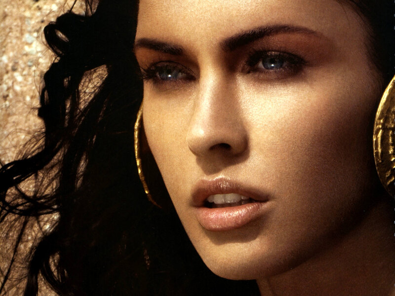 woman with blue eyes and gold earrings