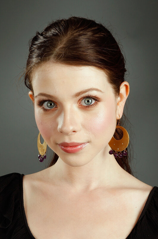 woman with blue eyes and gold earrings