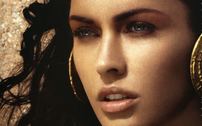 woman with blue eyes and gold earrings