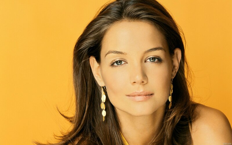 woman with blue eyes and gold earrings