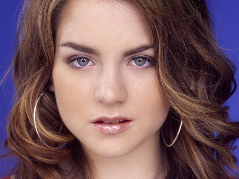 woman with blue eyes and hoop earrings