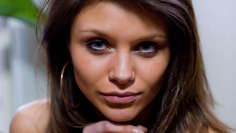 woman with blue eyes and hoop earrings