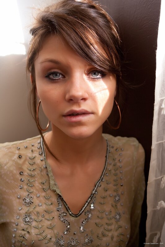 woman with blue eyes and hoop earrings
