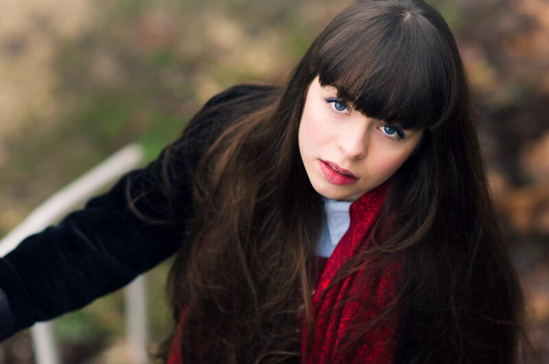 woman with blue eyes and red scarf