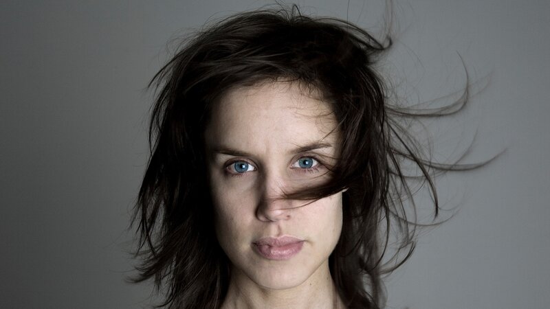 woman with blue eyes and windblown hair