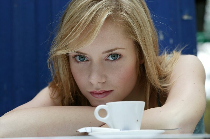 woman with blue eyes at table