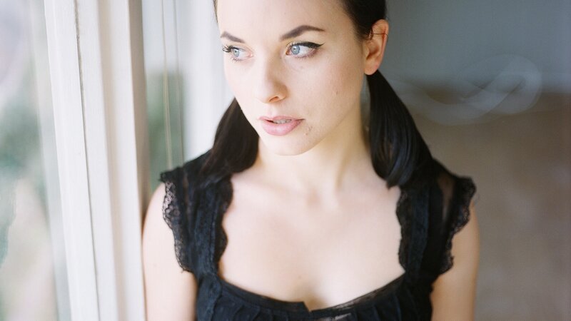 Woman with Blue Eyes — Black, Contemplative, Afternoon