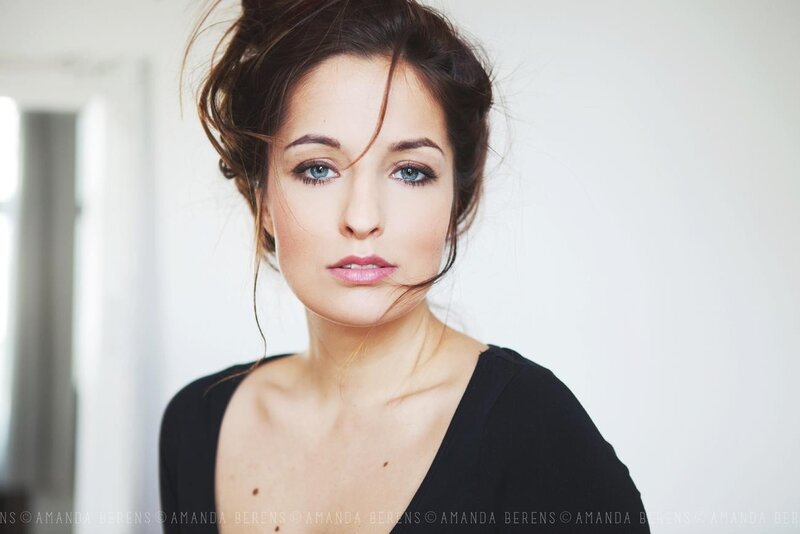 Woman with Blue Eyes — Black, Neutral, Photograph, Black Top, White Wall