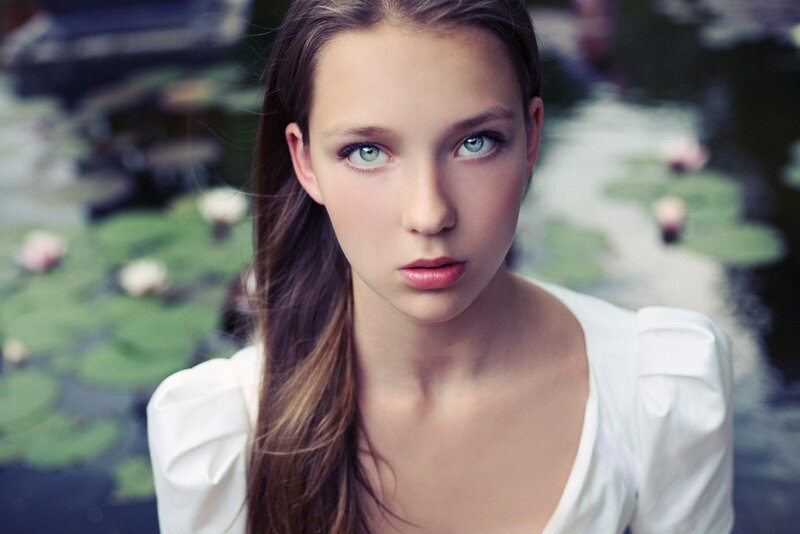 woman with blue eyes by pond