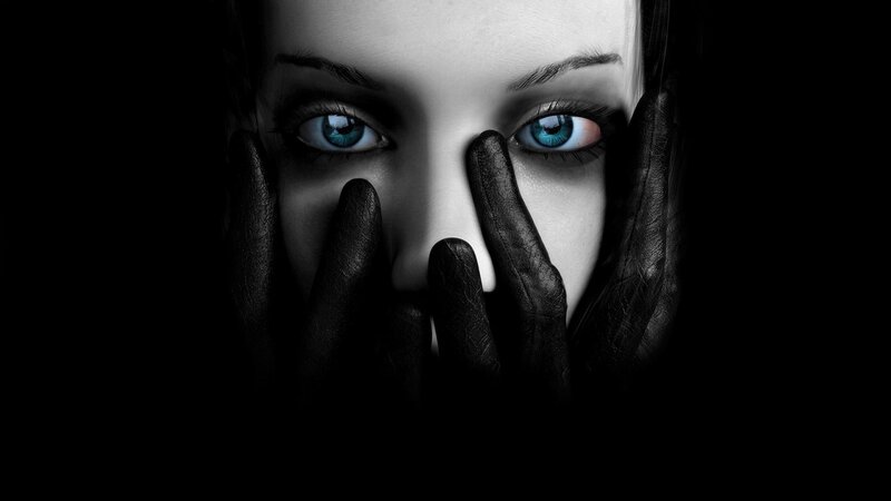 woman with blue eyes covering face