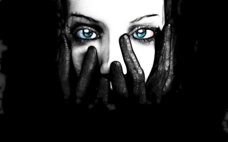 woman with blue eyes covering face