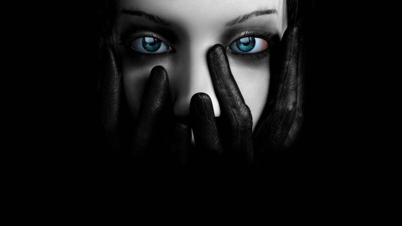woman with blue eyes covering face