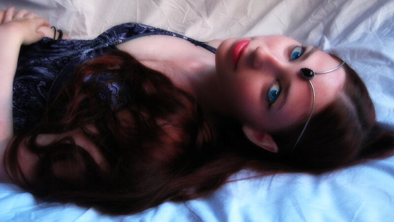 Woman with Blue Eyes — Dramatic, Photograph, Bed