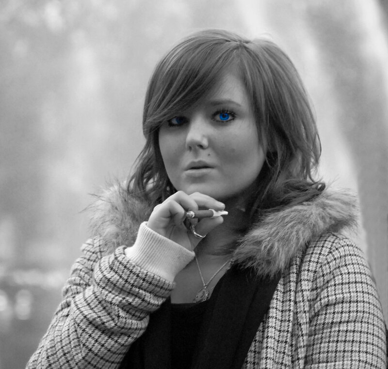 woman with blue eyes holding cigarette