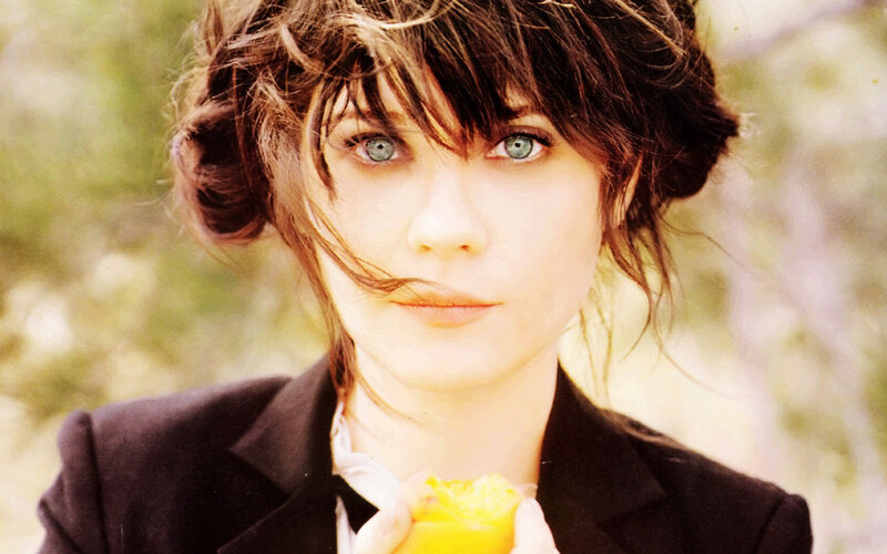 woman with blue eyes holding fruit