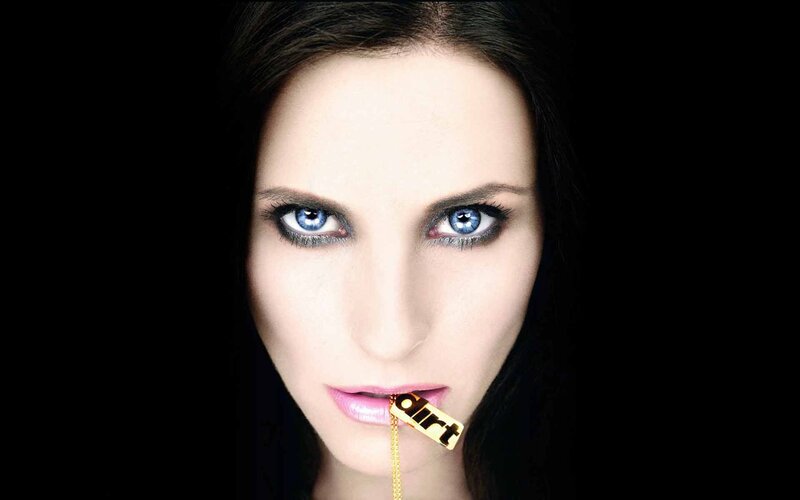 woman with blue eyes holding gold object