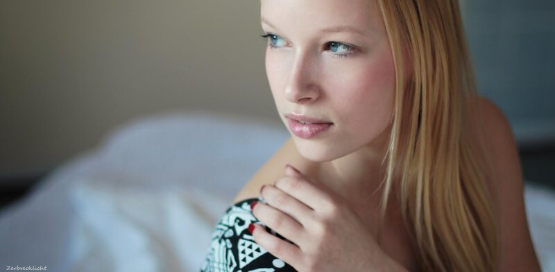 woman with blue eyes in bed
