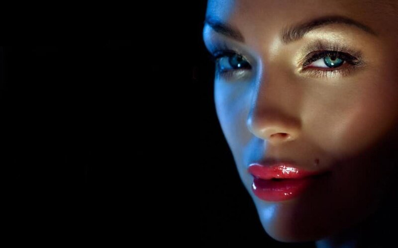 woman with blue eyes in dark
