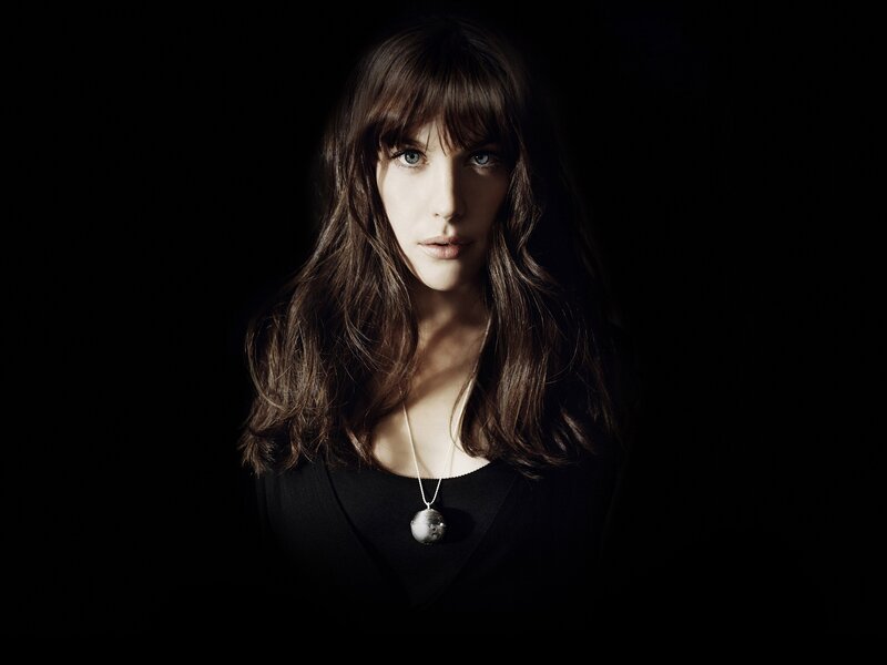 woman with blue eyes in dark setting