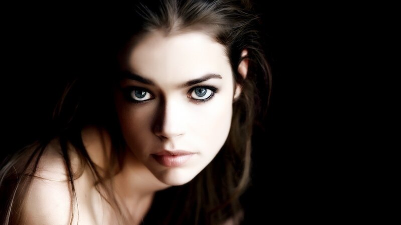 woman with blue eyes in dark setting