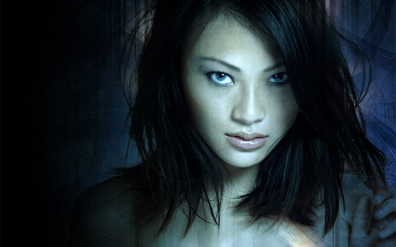 woman with blue eyes in dark setting
