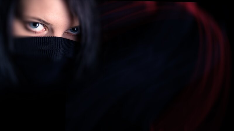 woman with blue eyes in dark setting
