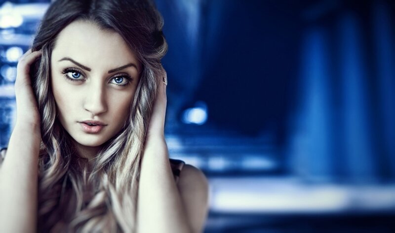 woman with blue eyes in dark setting