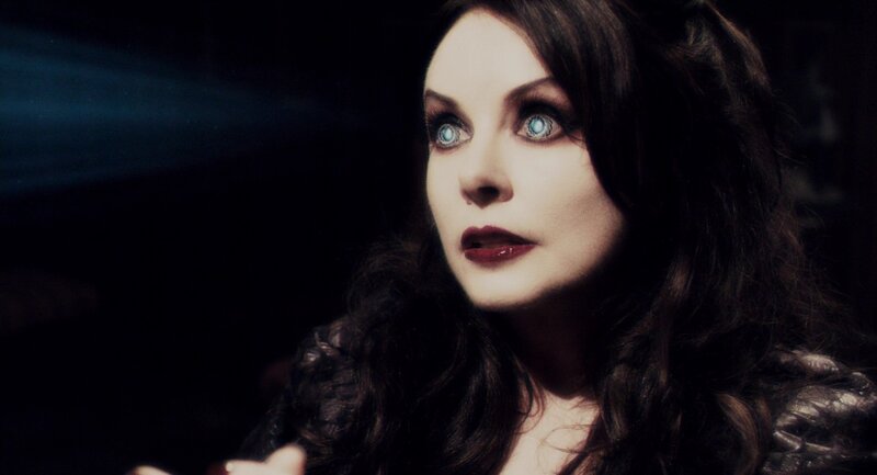woman with blue eyes in dark setting