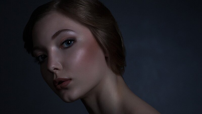 woman with blue eyes in dark studio