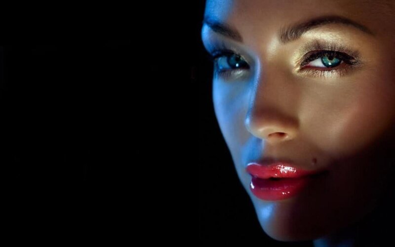 woman with blue eyes in dark