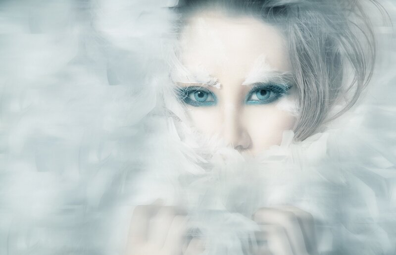 woman with blue eyes in feathers