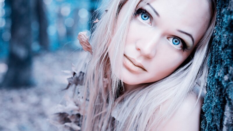 woman with blue eyes in forest