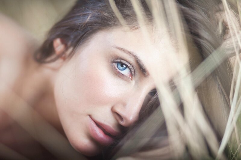 woman with blue eyes in grass