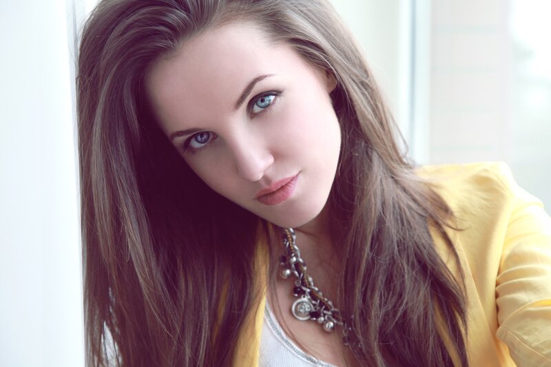 woman with blue eyes in yellow jacket