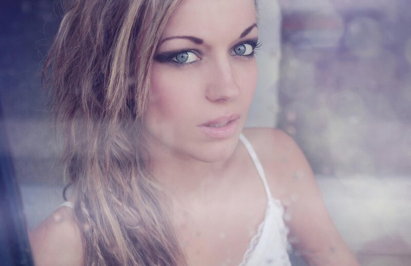 woman with blue eyes looking through glass