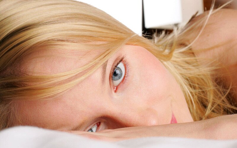 woman with blue eyes lying down