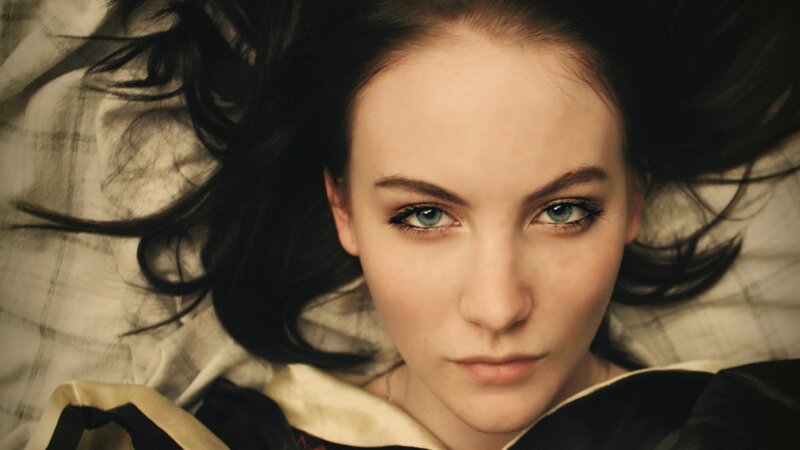 woman with blue eyes lying down