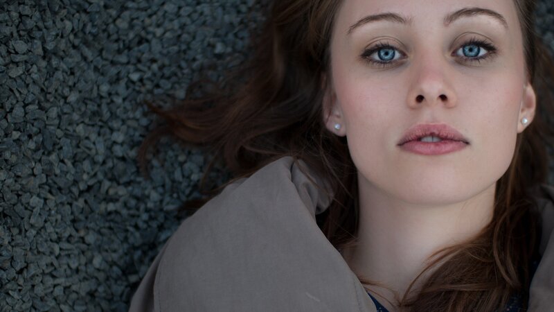 woman with blue eyes lying down