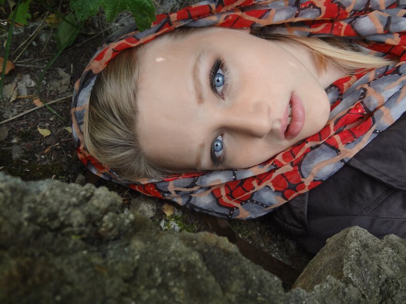 woman with blue eyes lying on ground