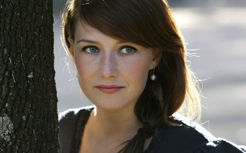 woman with blue eyes near tree
