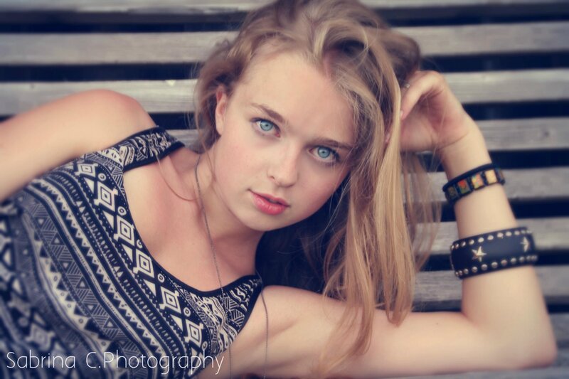 woman with blue eyes on bench