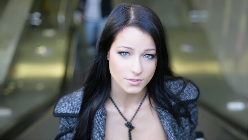 woman with blue eyes on escalator